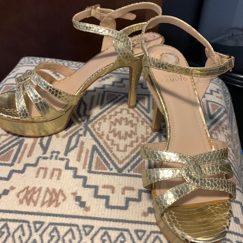 Gorgeous gold high heel with platform in the front.